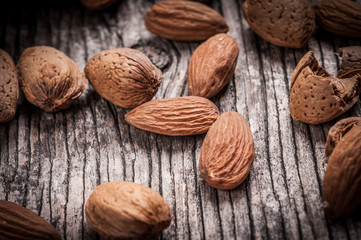 Wall Mural - Tasty almond nuts on rustic wooden background