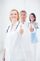 Wall Mural - team of doctors showing thumbs up