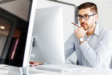 Wall Mural - Male office worker sitting at desk