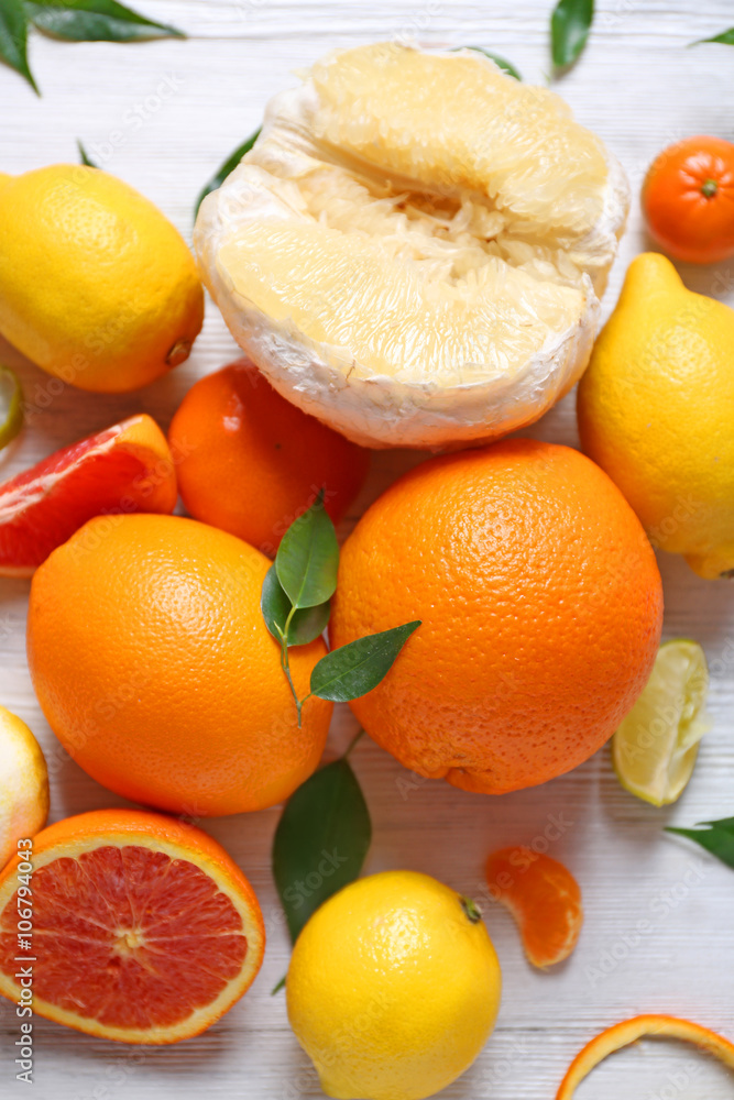 Various citrus fruits on wooden table