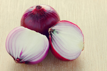 selective focus purple onion on wood background.