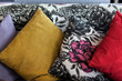 Colorful handmade pillows on sofa in cafe