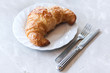 Butter croissant on white plate