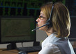 Female operator  with headphone in power distribution control ce