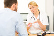© Production Perig - Young attractive woman doctor giving pills to a patient