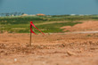 © wavemovies - Metal survey peg with red flag on construction site