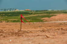 Metal Survey Peg With Red Flag On Construction Site