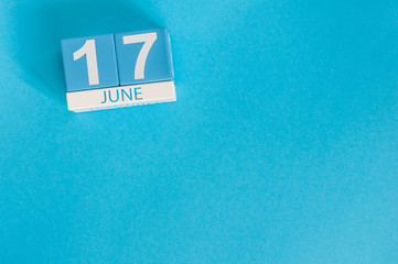 Wall Mural - June 17th. Image of june 17 wooden color calendar on blue background. Summer day. Empty space for text