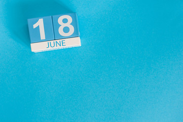 Wall Mural - June 18th. Image of june 18 wooden color calendar on blue background. Summer day. Empty space for text