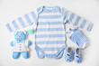 Baby clothes with toys on white background