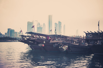 Canvas Print - Abu Dhabi buildings skyline with old fishing boats