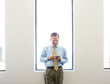 © Sam Diephuis/Blend Images - Caucasian businessman using cell phone in office