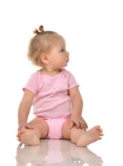 Wall Mural - Infant child baby girl toddler sitting and looking up