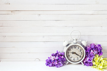 Poster - Background with white alarm clock and hydrangea flowers on white