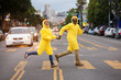 © Adam Hester/Blend Images - Couple in chicken costumes crossing city street