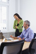 © Don Mason/Blend Images - Business people working on laptop in conference room