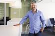 © Don Mason/Blend Images - Caucasian businessman smiling in office