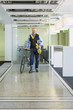 © Don Mason/Blend Images - Caucasian businessman with bicycle in office