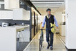 © Don Mason/Blend Images - Caucasian businessman with bicycle in office