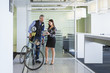 © Don Mason/Blend Images - Business people using digital tablet in office