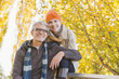 © Mike Kemp/Blend Images - Older Caucasian couple smiling under autumn trees