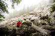 © Aleksander Rubtsov/Blend Images - Caucasian hiker climbing rocky hillside
