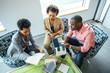 © Inti St Clair/Blend Images - High angle view of business people examining swatches in office lobby