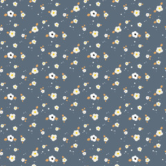 Wall Mural - Spring small wild flower field seamless pattern. Floral blue and mustard fine summer vector pattern on dark blue background. For fabric textile prints and apparel.