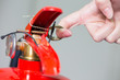 Close- up Fire extinguisher and pulling pin on red tank.