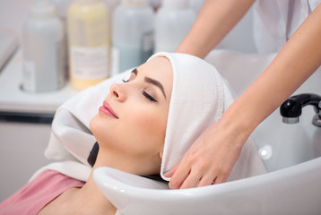 Wall Mural - Beautiful woman sitting in the hairdressing salon  