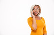 © Drobot Dean - Happy african american woman standing and talking on cell phone