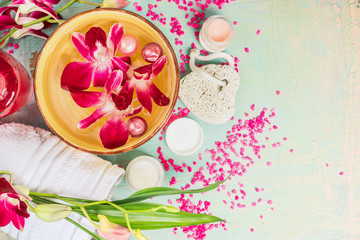 Wall Mural - Spa tools for body care, flowers and water bowl on light wooden background, top view, border. Wellness concept.