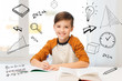 © Syda Productions - smiling student boy writing to notebook at home