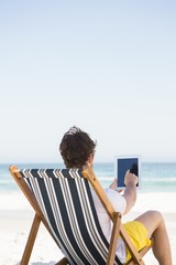 Man relaxing and using tablet