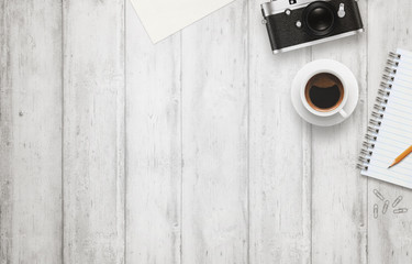 Leinwandbilder - Office desk with free space for text. Camera, cup of coffee, paper, notepad, pencil on white wooden table. Top view.