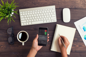 Aufkleber - hand checking stock graph on phone and write note