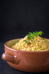 Wall Mural - Couscous with vegetables on black stone
