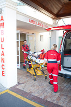 Paramedics Moving Patient Through Hospital Doorway