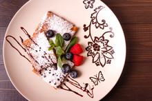 Honeyed Cake With Ginger Dusted With Icing Sugar With Raspberry, Bilberry, Mint On  Plate On Wooden Background. Top View.
