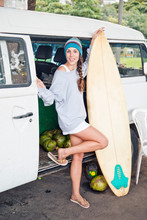 Young Woman With Surfboard By Campervan