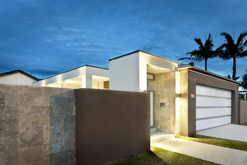 Modern house entrance at night with lights on