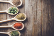 © Leszek Czerwonka - Aromatic herbs and spices on wooden spoons