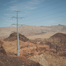 Desert Landscapes With Red Rocks And Electric Poles