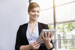 © Connect Images - Portrait of young businesswoman with digital tablet