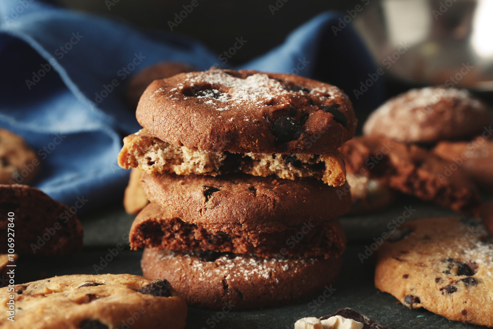 Chocolate chip cookies beside napkin on wooden background