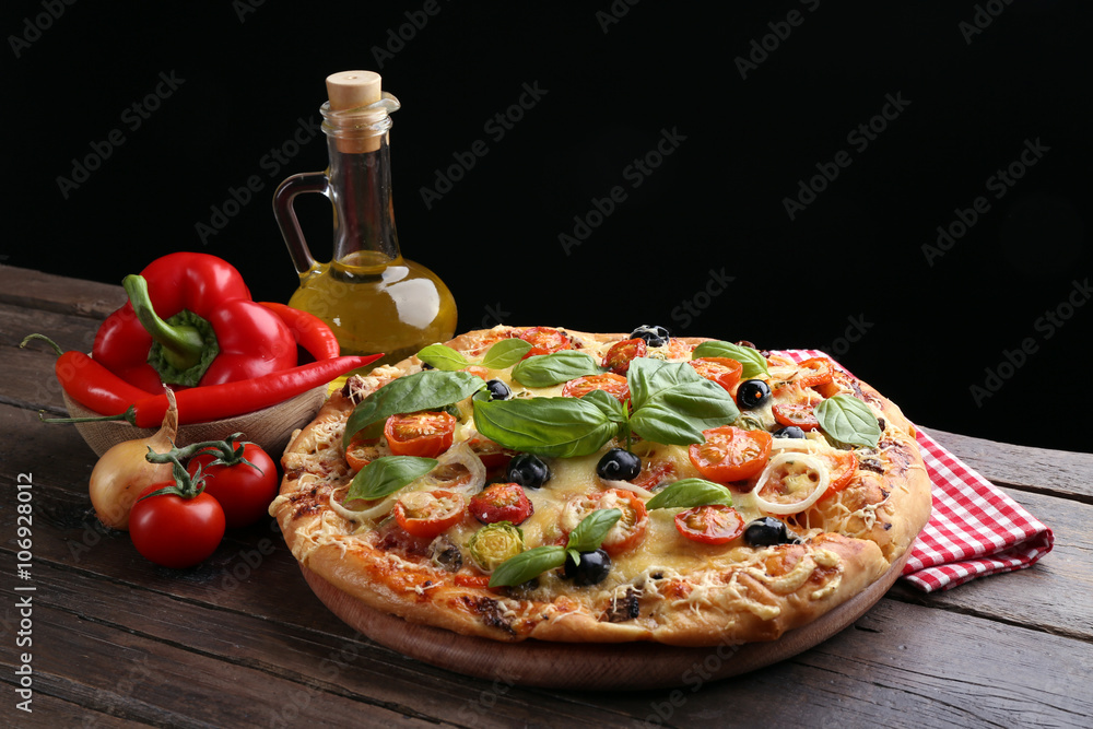 Delicious fresh pizza on black background