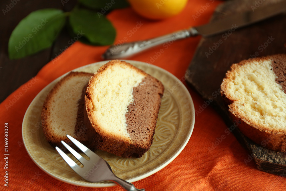 Delicious sweet cake bread in plate on orange napkin closeup