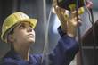 © Connect Images - Female engineer checking valves and cables in factory
