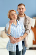 © Africa Studio - Young happy couple holding keys from their new apartment