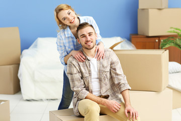 Wall Mural - Happy young couple moving in their new apartment